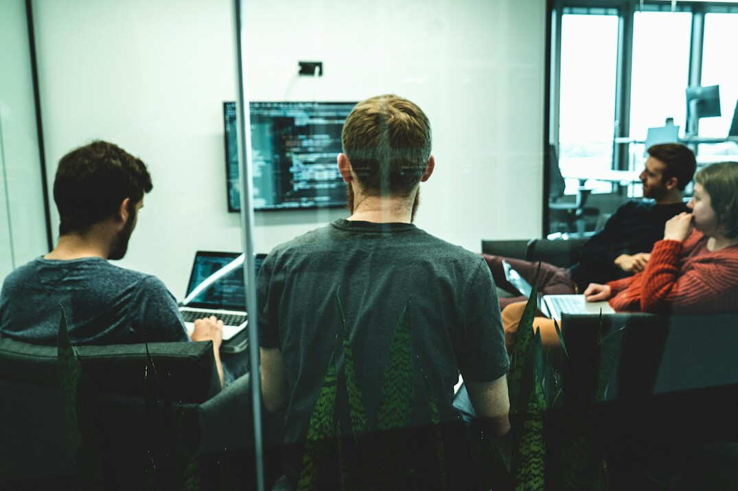 corporate team discussing code